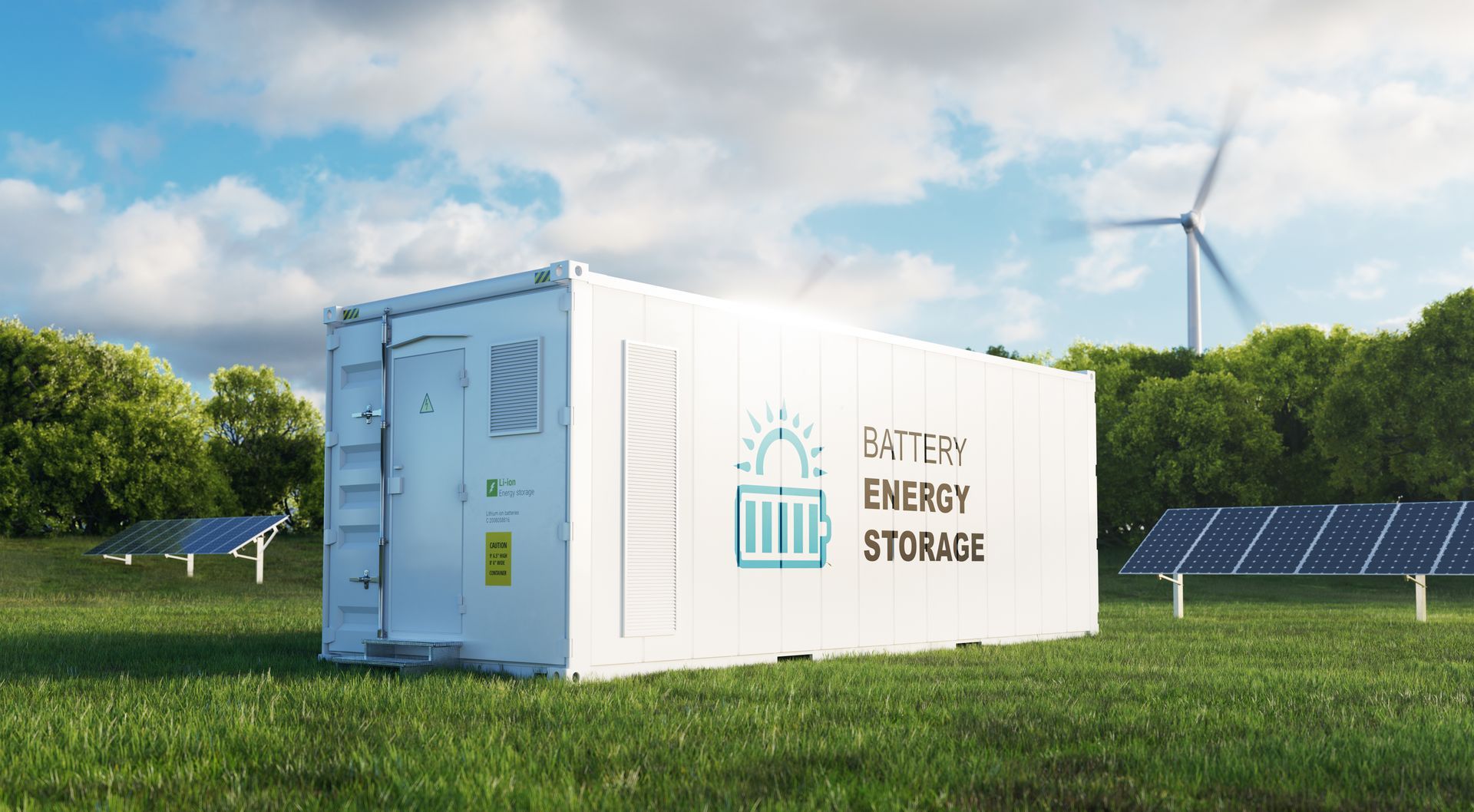 A white shipping container is sitting in a grassy field next to solar panels and wind turbines.