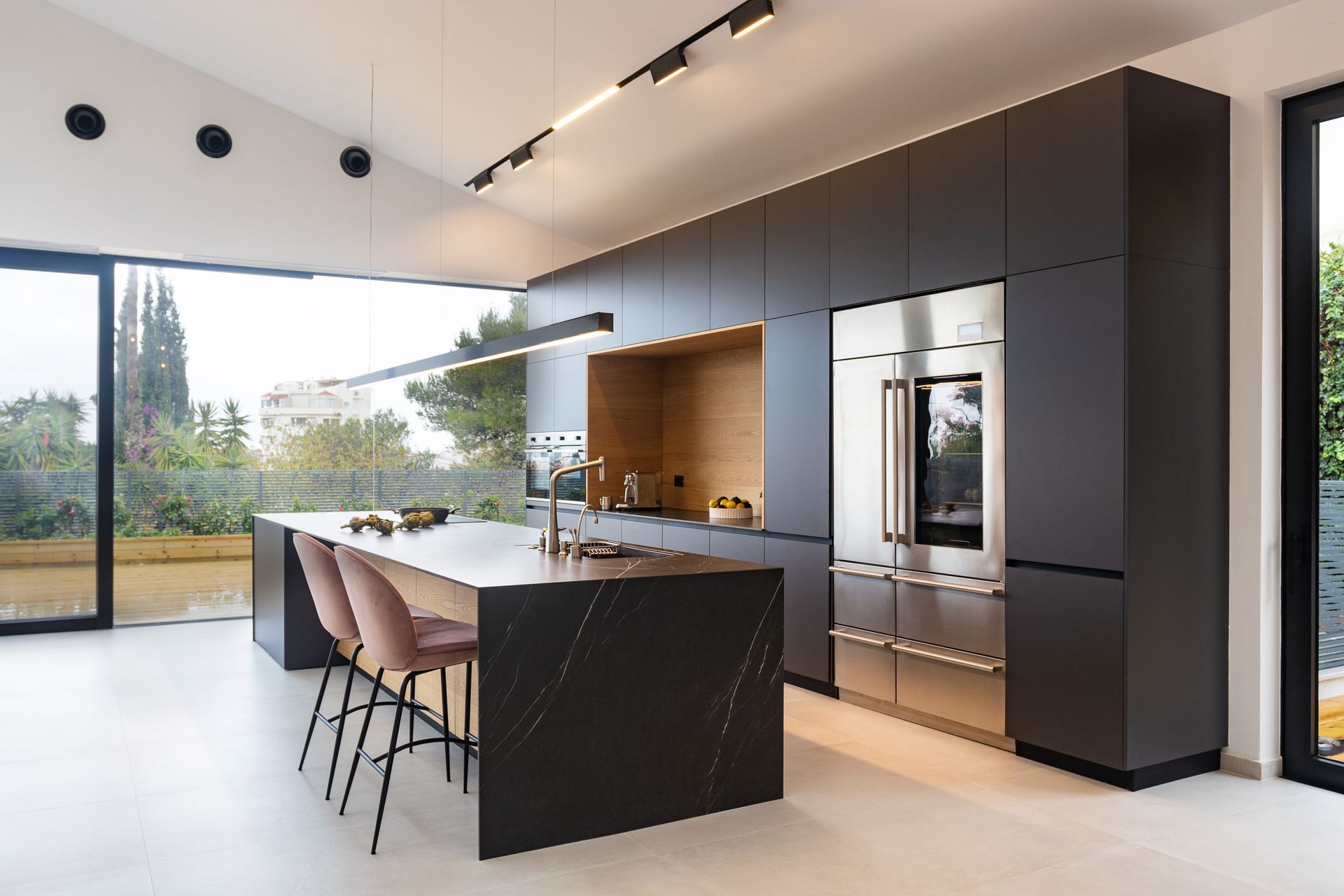 A kitchen with a large island and stainless steel appliances