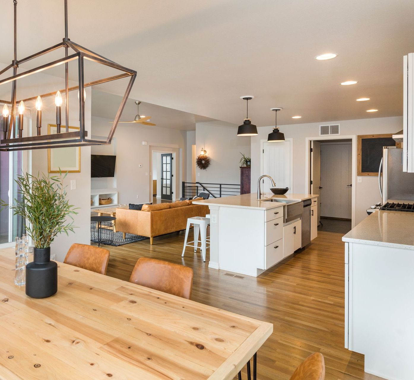 A living room with a couch and a kitchen in the background.