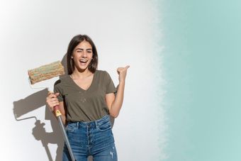 A woman wearing a brown shirt with a paint roller | Sydney, NSW | Polypaint