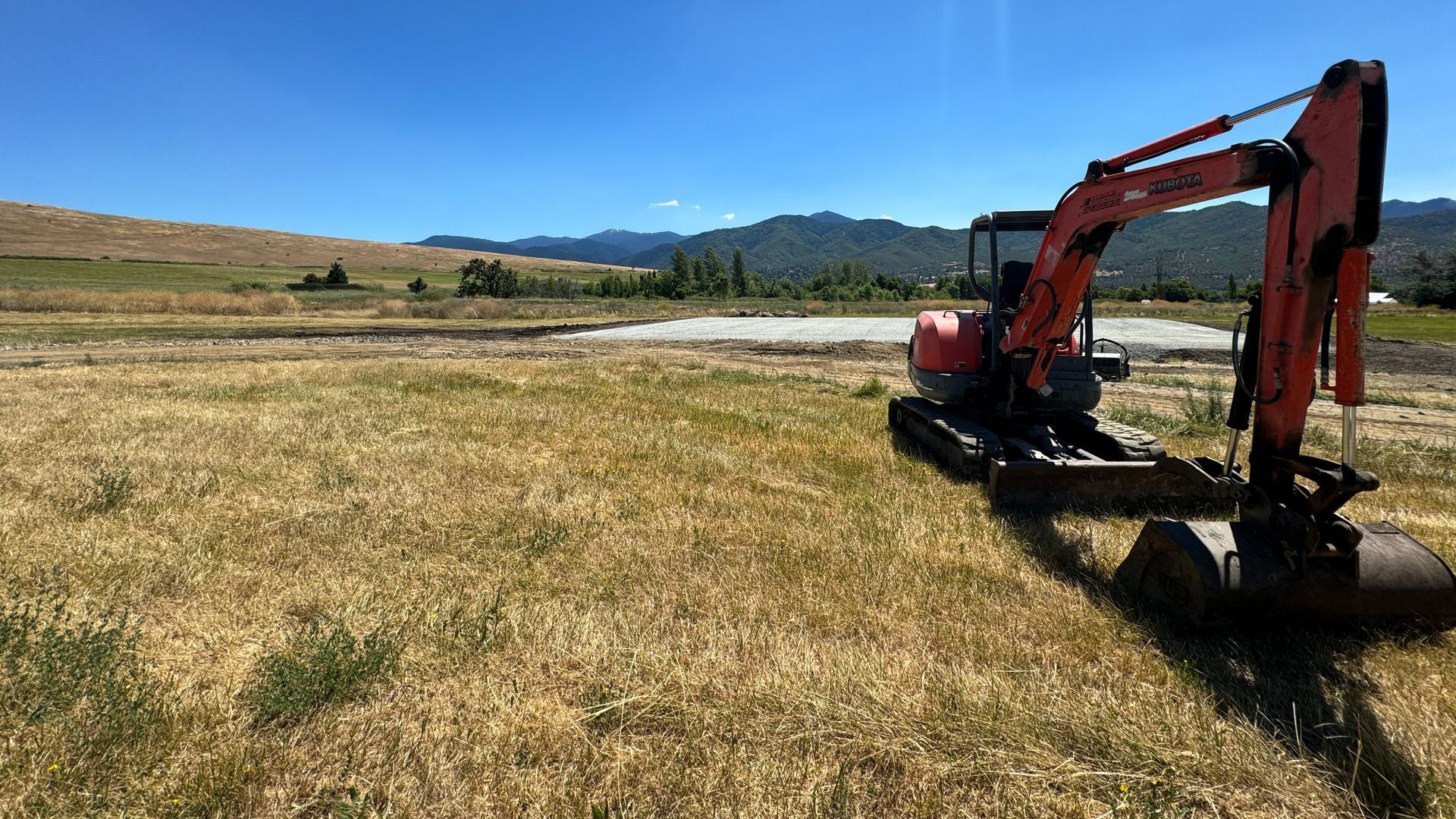 Excavator building a house pad in ashland, oregon