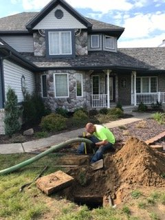 Septic Tank Cleaning  — Hose in Man Hole in Mount Morris, MI