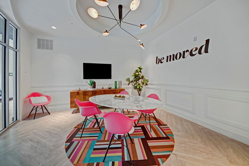 The resident lounges with a table, chairs, and a sign.