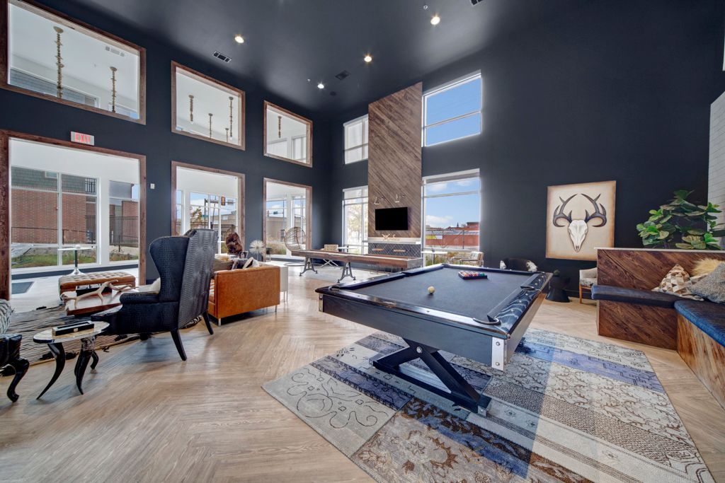 There is a pool table in the middle of the room.