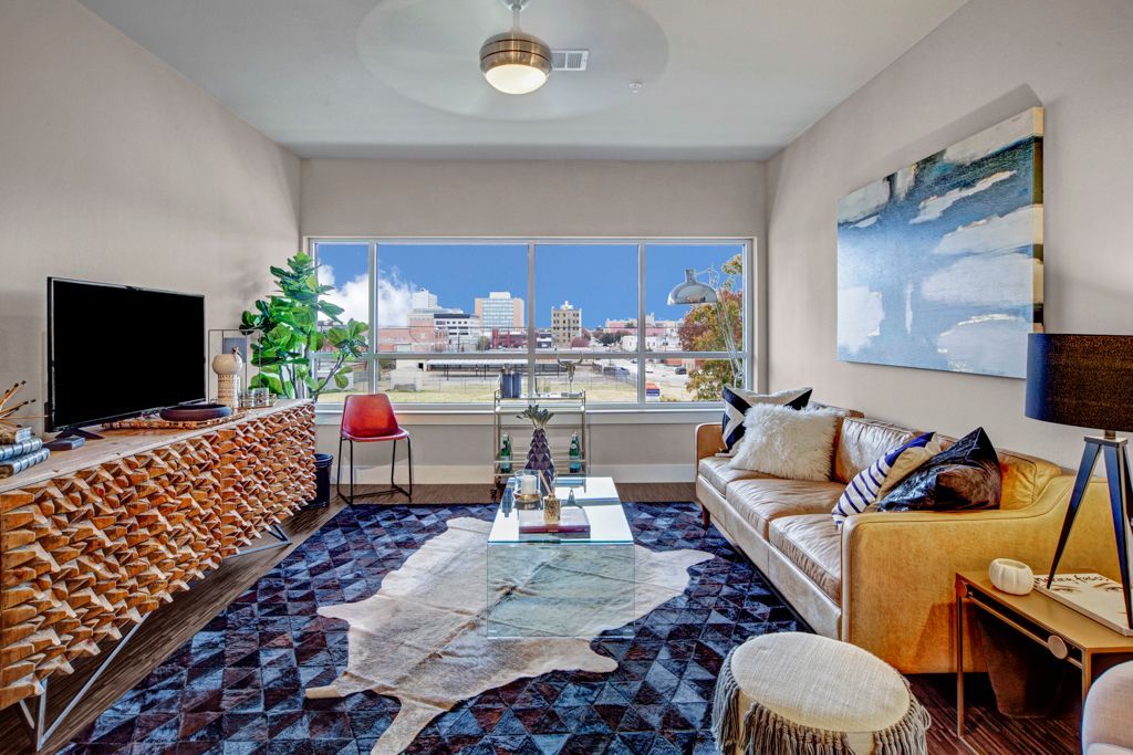 A living room with a couch, coffee table, and television.