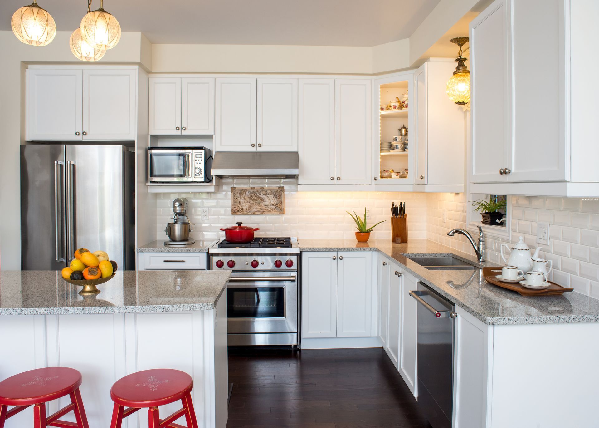 A kitchen with white cabinets and stainless steel appliances