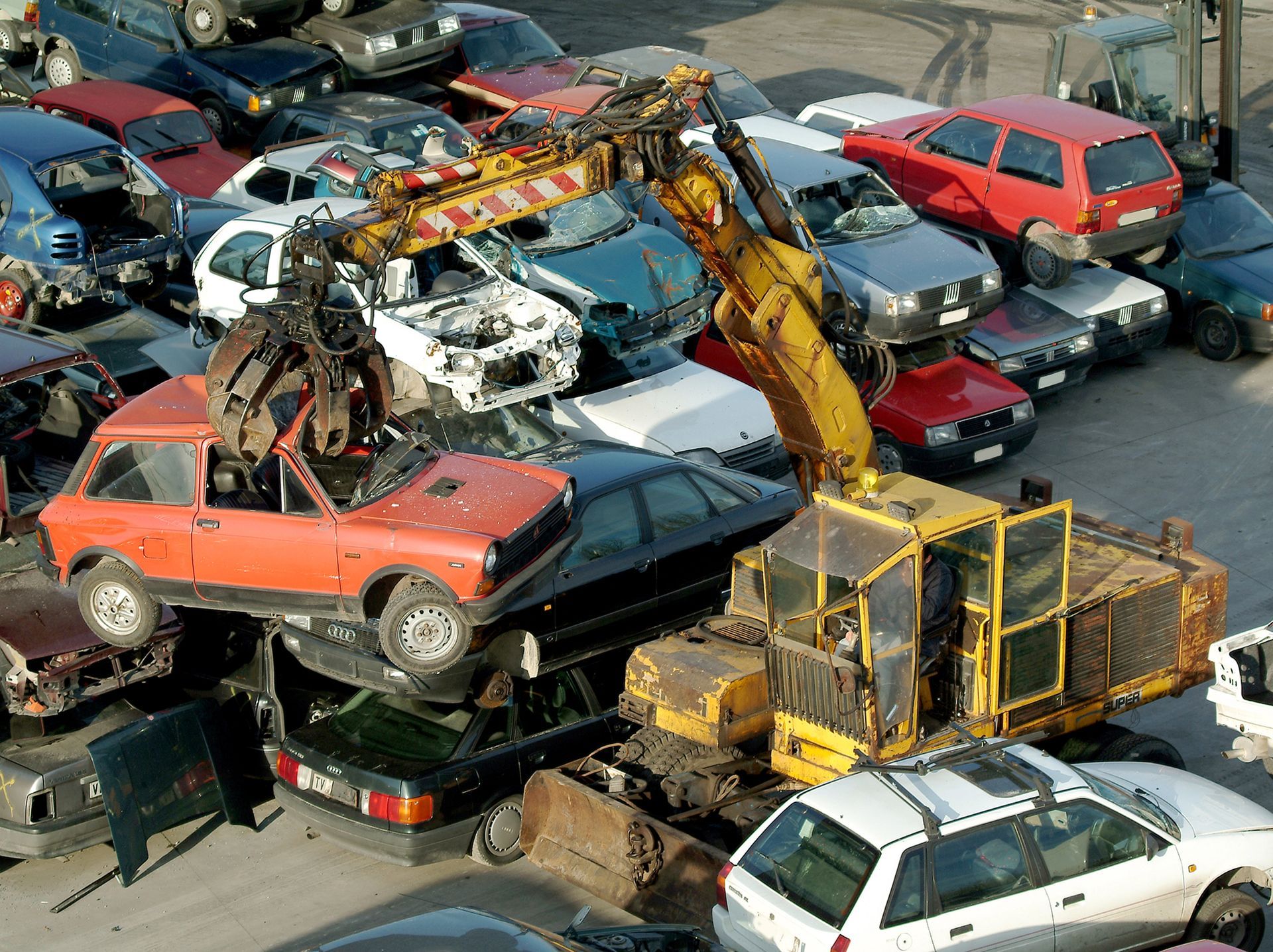 Parti del motore, tra cui pistoni, bielle e valvole, esposte su un tavolo.