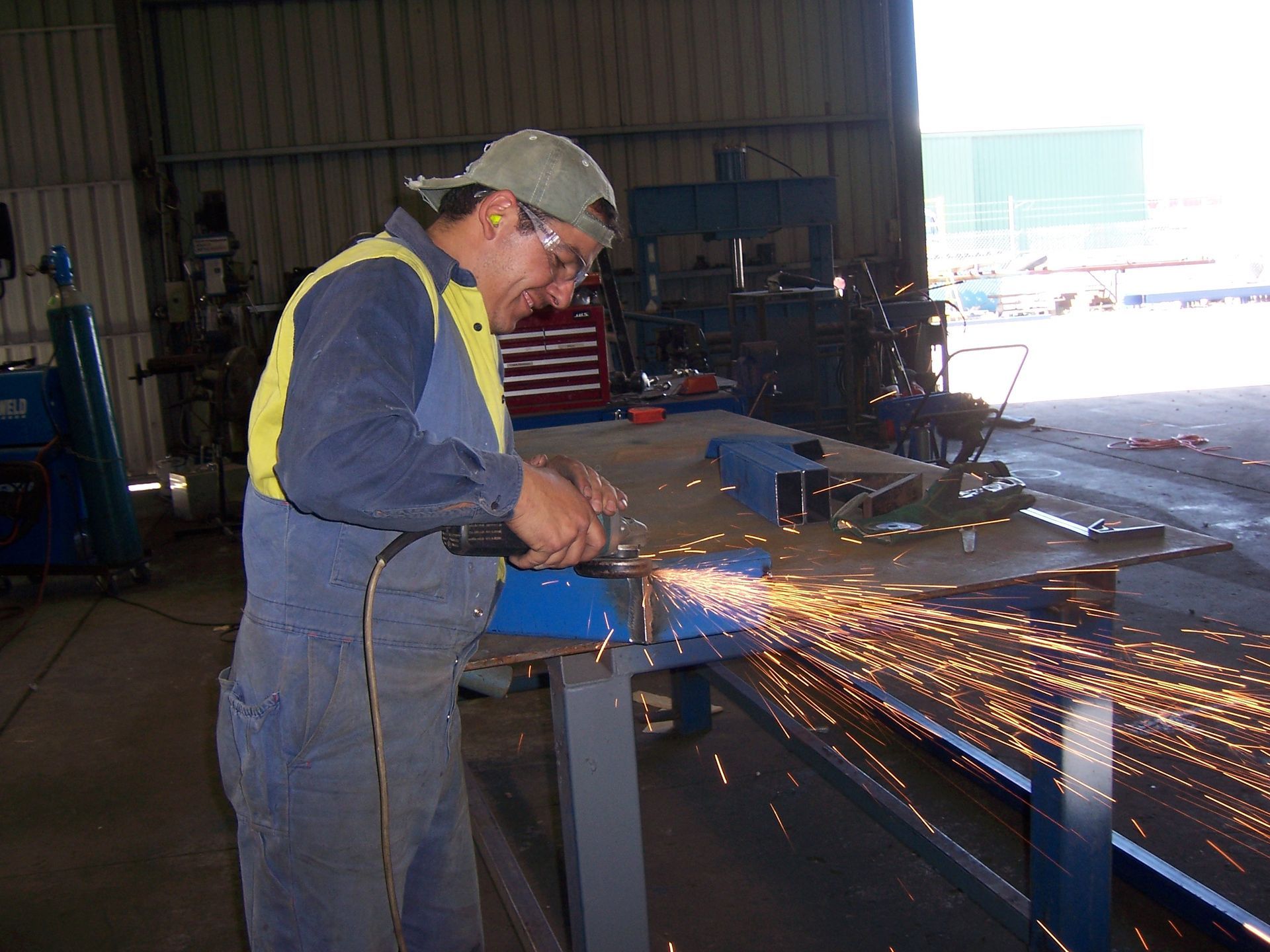 A Man Is Working On A Piece Of Metal With Sparks Flying Out — TMF Engineering In Echuca, VIC