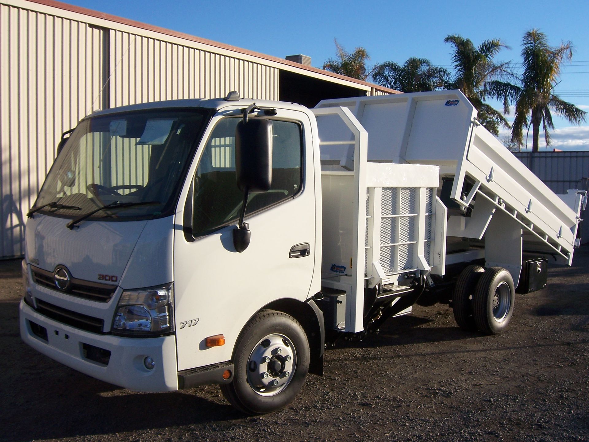 A white dump truck is parked in front of a building — TMF Engineering In Benalla, VIC