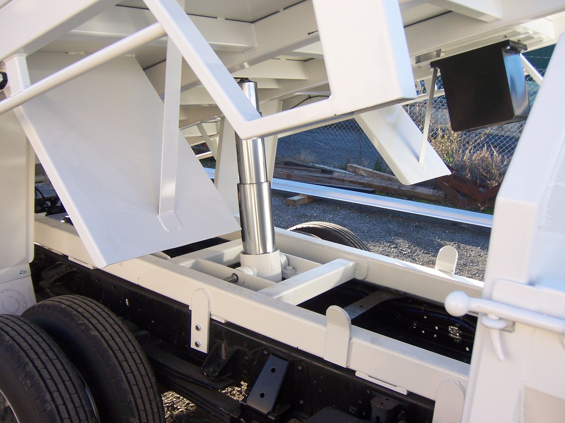 A white truck with a hydraulic system on the back — TMF Engineering In Benalla, VIC
