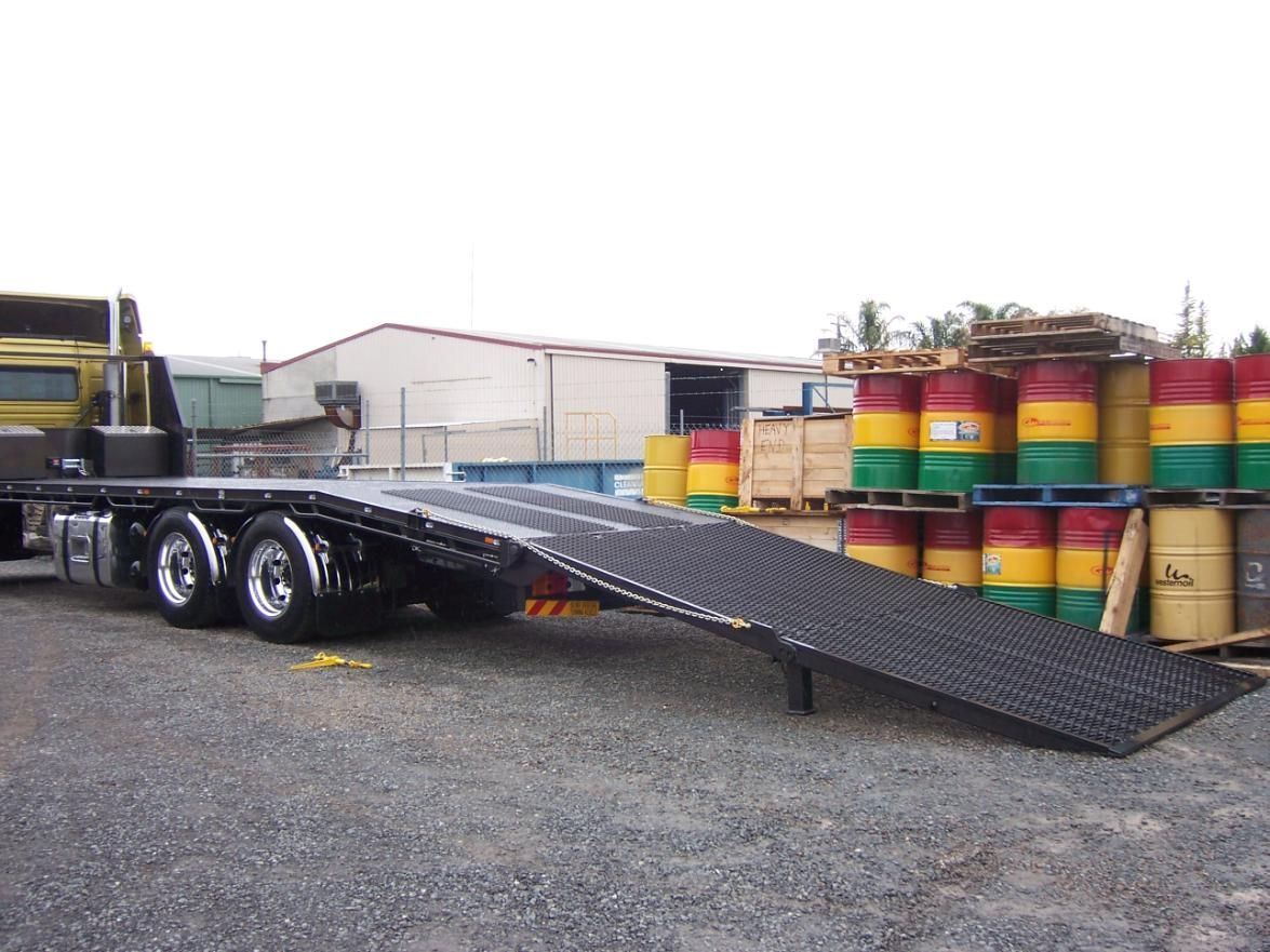 A Truck Is Parked Next To A Stack Of Barrels — TMF Engineering In Benalla, VIC