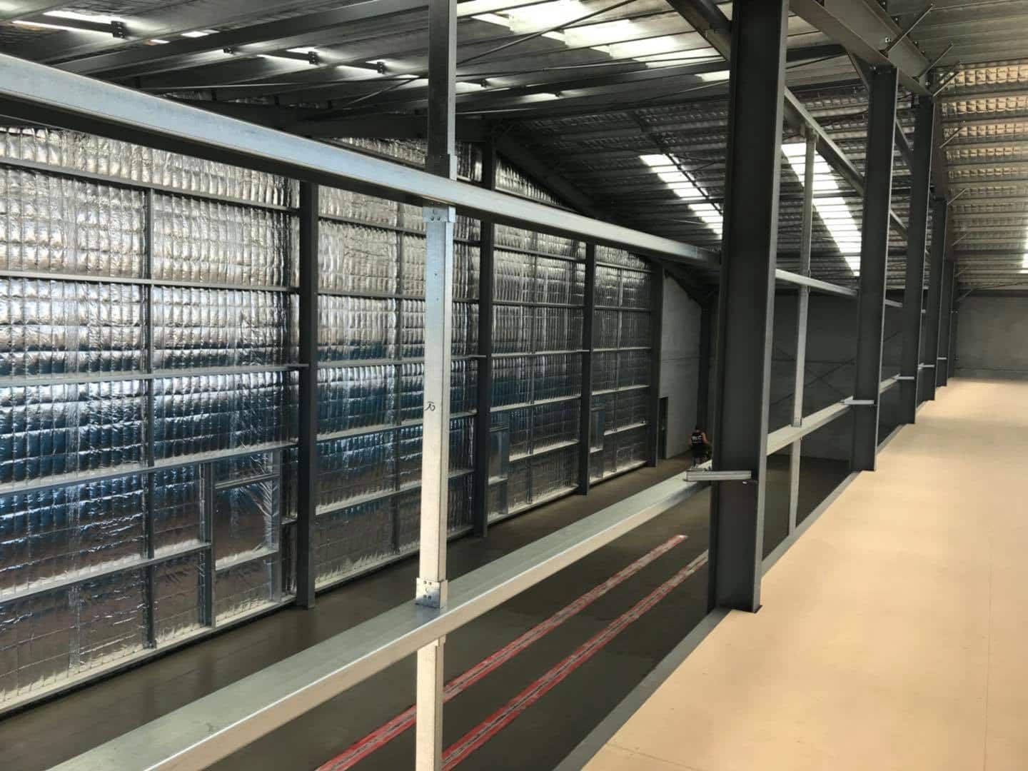 A Long Hallway In A Building With A Metal Railing — TMF Engineering In Cobram, VIC