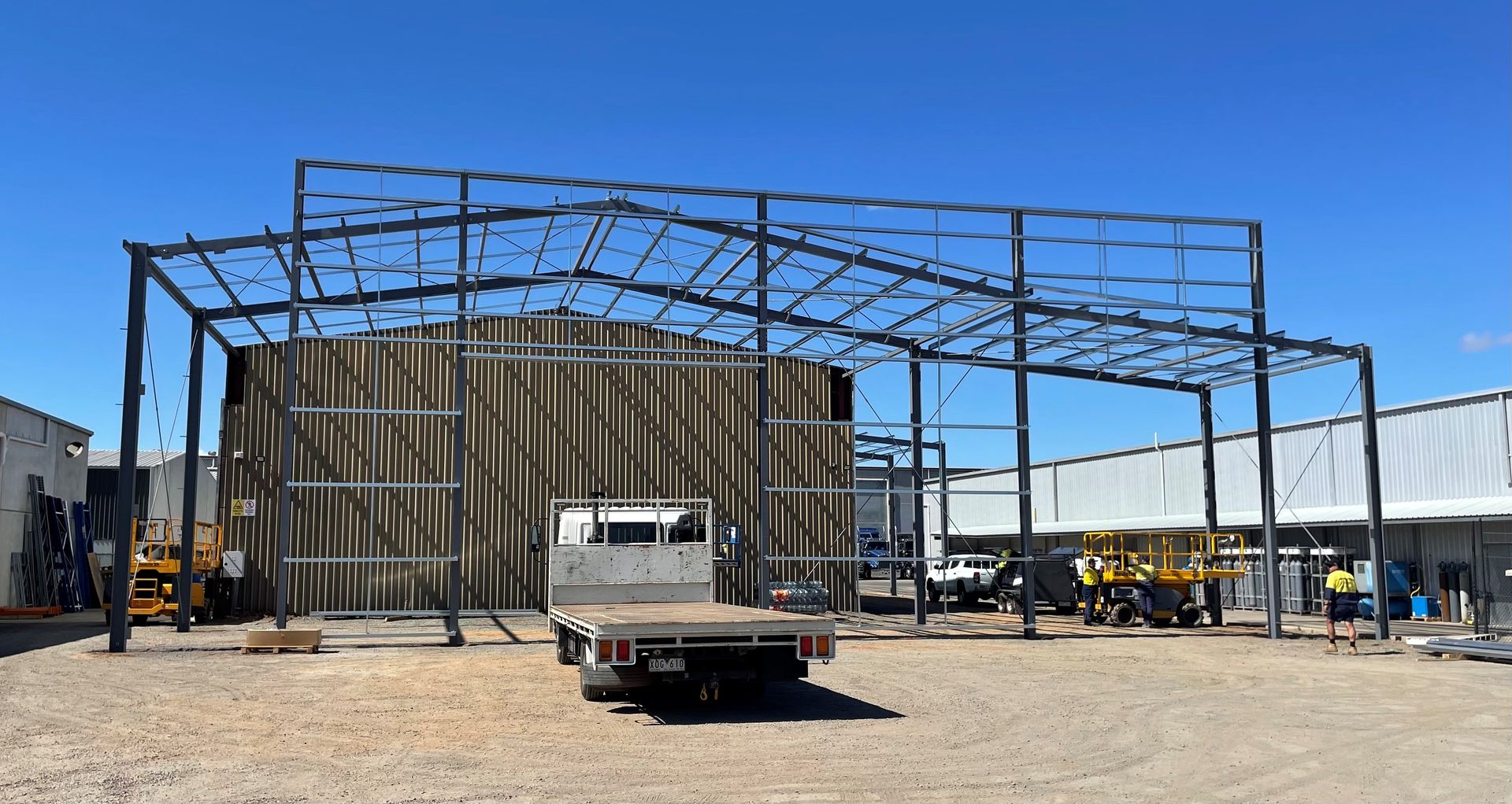 A truck is parked in front of a building under construction — TMF Engineering In Benalla, VIC