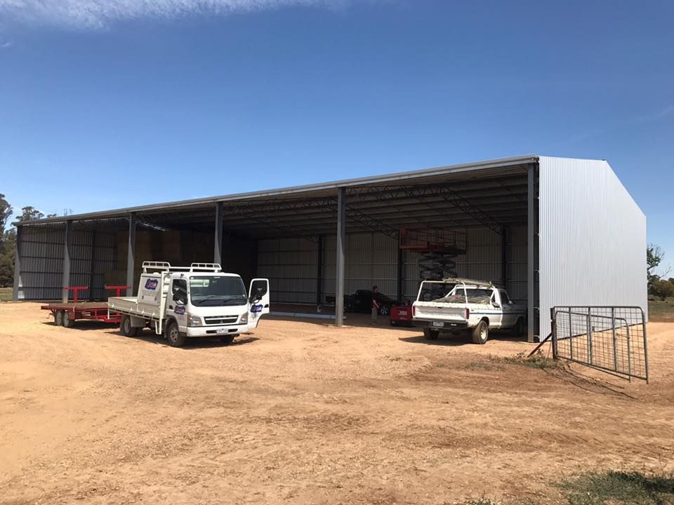 Two trucks are parked in front of a large building — TMF Engineering In Benalla, VIC