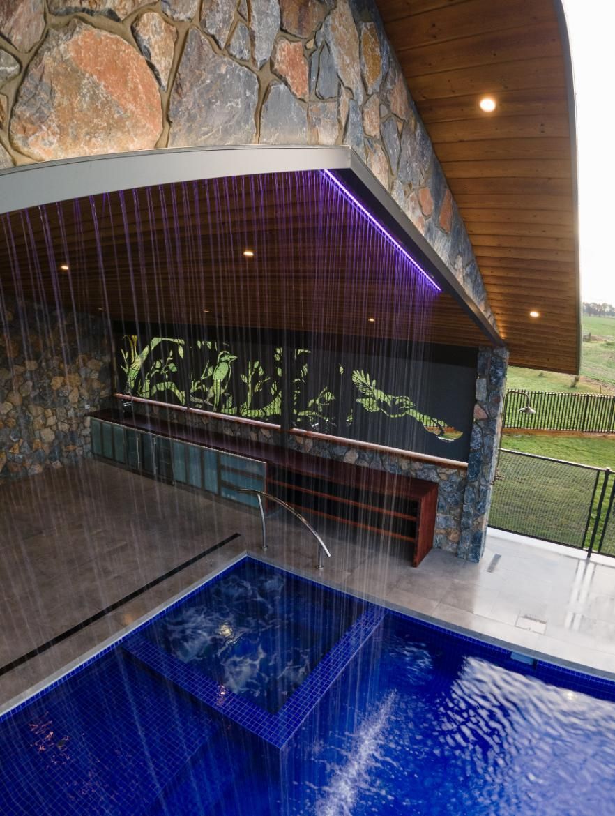 A Swimming Pool With Custom Shed Waterfall In The Middle Of It — TMF Engineering In Shepparton, VIC