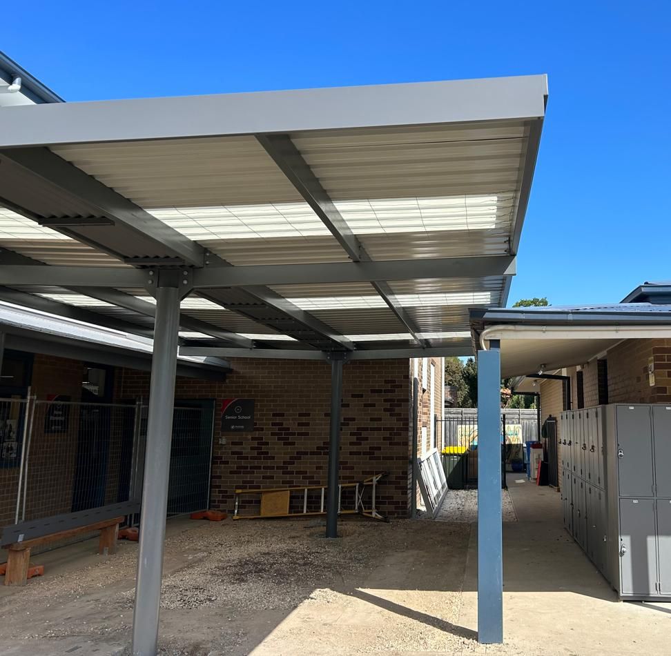 A Brick Building With A Covered Walkway Leading To It — TMF Engineering In Shepparton, VIC