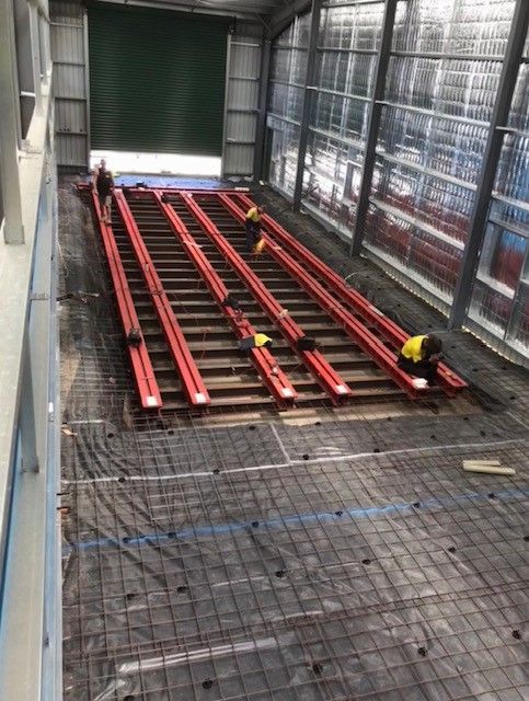 A group of people are working on a large staircase in a building — TMF Engineering In Benalla, VIC