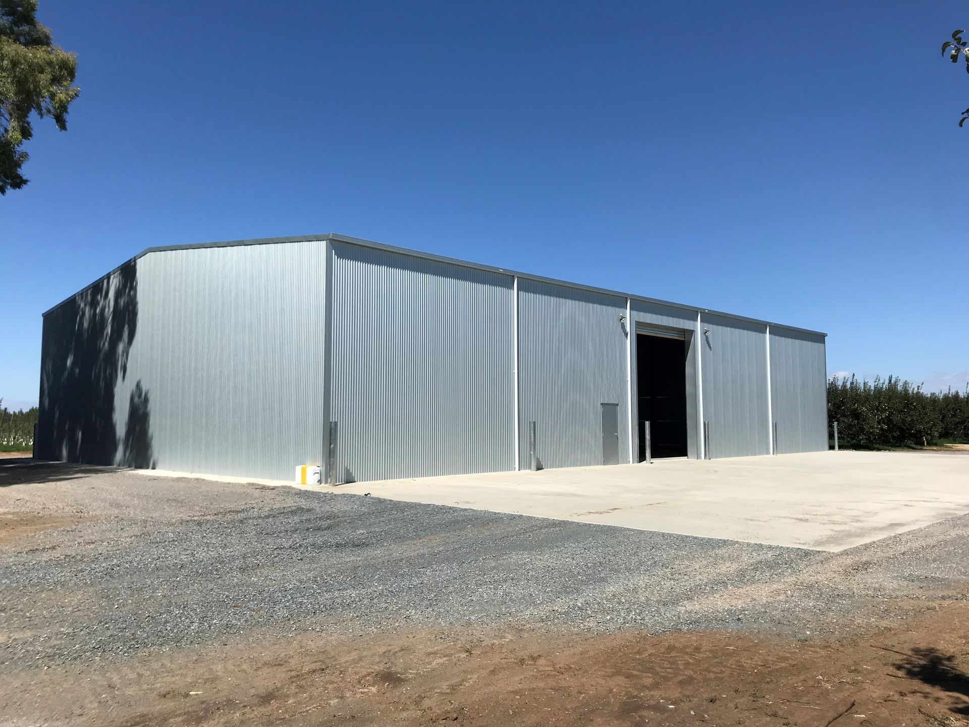 A large metal building is sitting in the middle of a gravel road — TMF Engineering In Benalla, VIC
