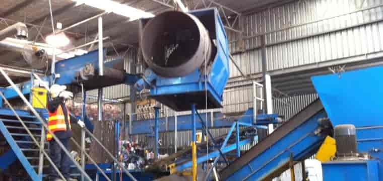 A Man Is Working On A Machine In A Factory — TMF Engineering In Numurkah, VIC