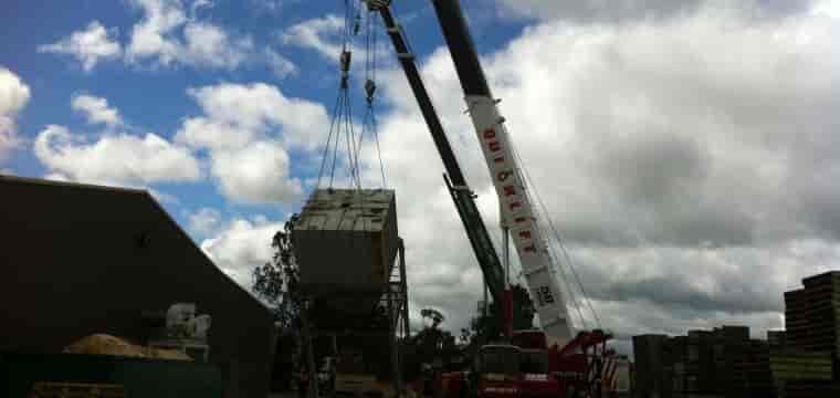 A Large Crane Is Lifting A Building In The Air — TMF Engineering In Echuca, VIC
