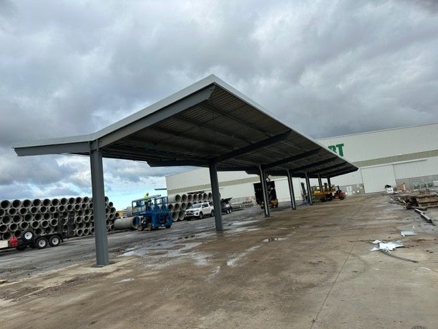 A parking lot with a covered area in front of a building — TMF Engineering In Benalla, VIC