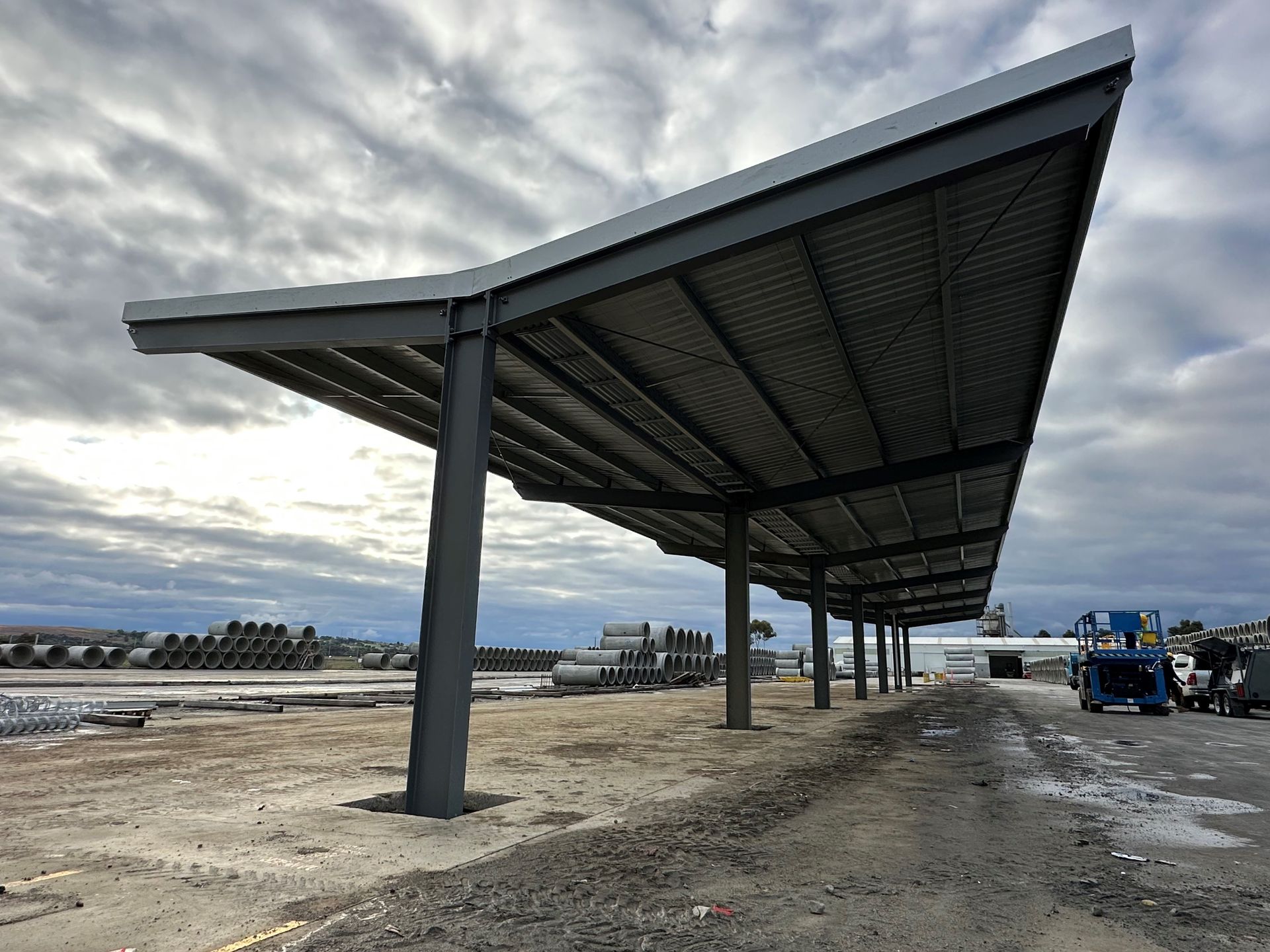 A large metal structure is being built in the middle of a dirt field — TMF Engineering In Benalla, VIC