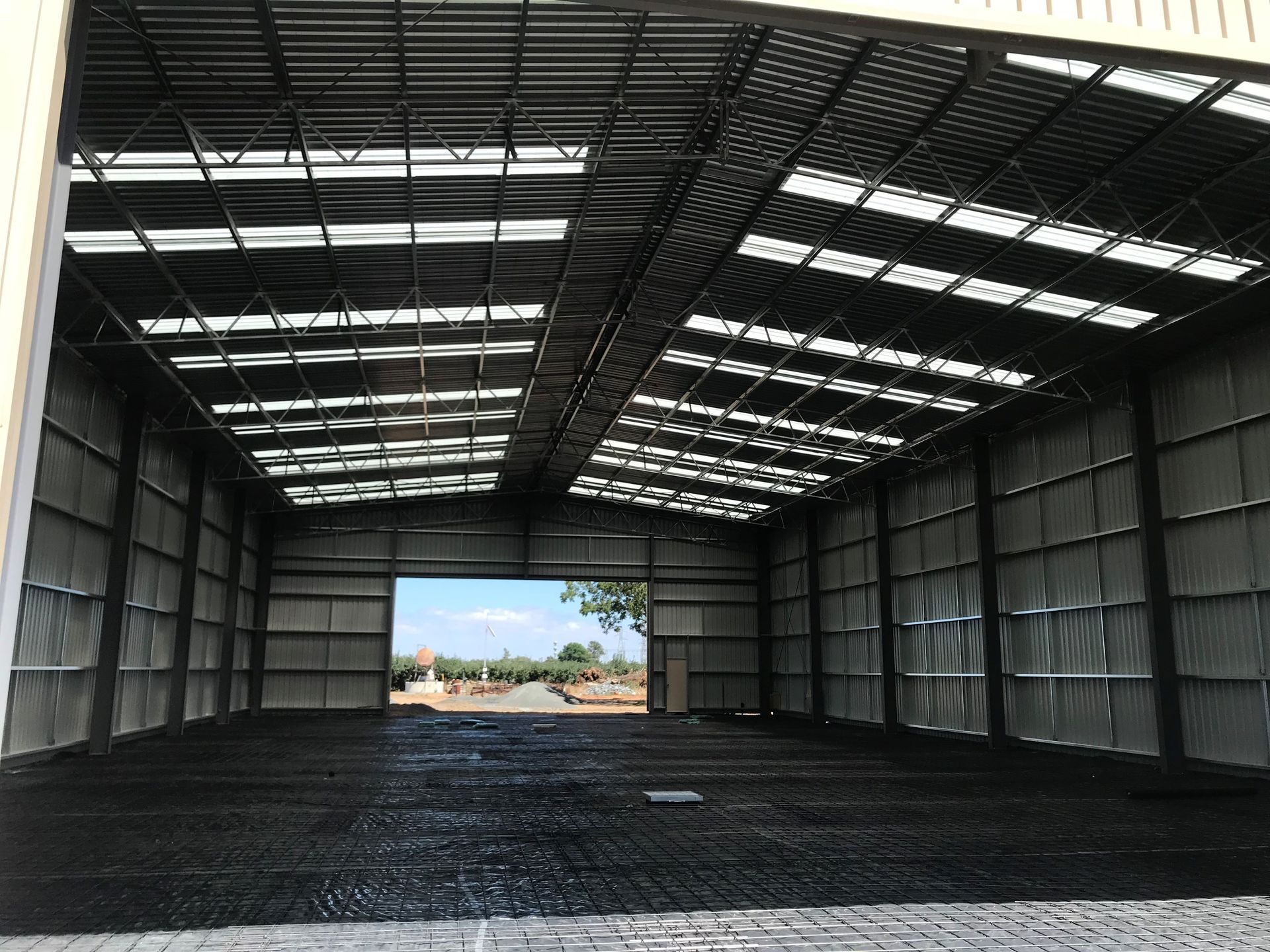 A large warehouse with a lot of windows and a roof — TMF Engineering In Benalla, VIC