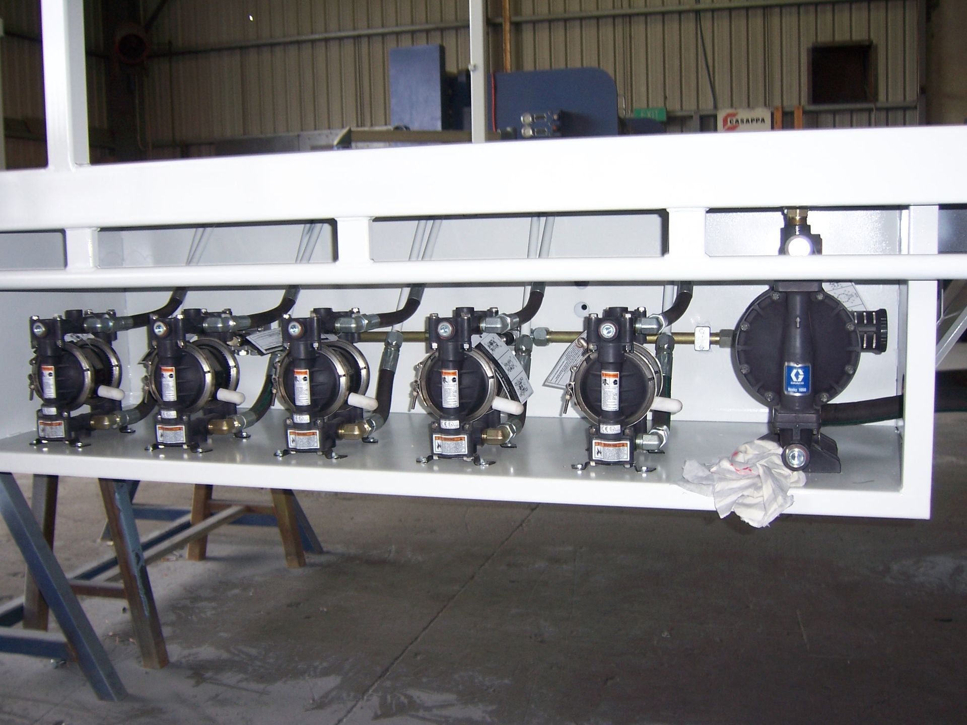 A row of black pumps are lined up on a white shelf — TMF Engineering In Benalla, VIC