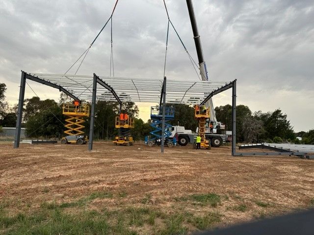 A Crane Is Lifting A Metal Structure In A Field — TMF Engineering In Echuca, VIC