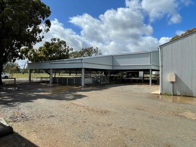 A Large White Building With A Covered Area Underneath It — TMF Engineering In Benalla, VIC