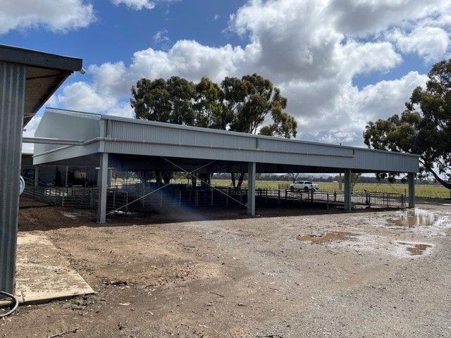 A Large Building Is Sitting In The Middle Of A Dirt Field — TMF Engineering In Shepparton, VIC