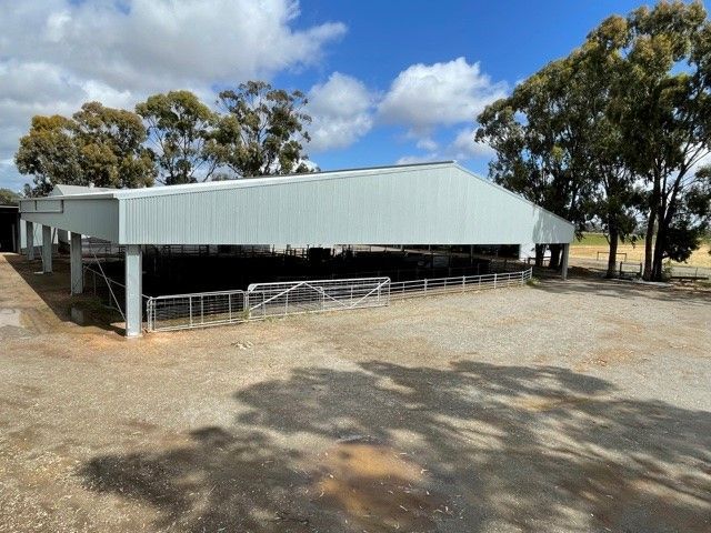 A large building with a white roof is surrounded by trees and dirt — TMF Engineering In Benalla, VIC