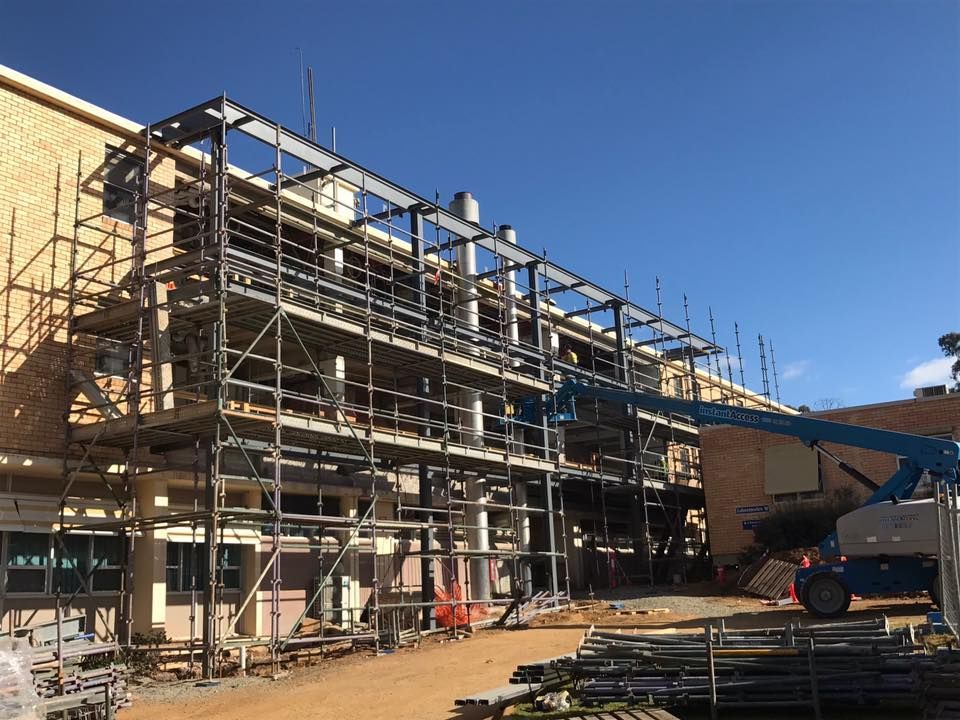 A large building is being built with scaffolding and a crane — TMF Engineering In Benalla, VIC
