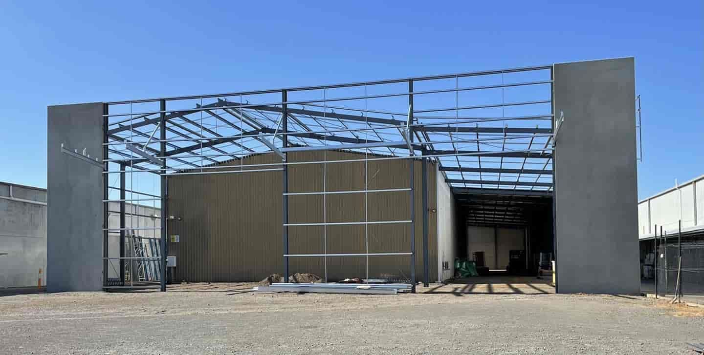 A Large Metal Structure Is Being Built In A Gravel Lot — TMF Engineering In Numurkah, VIC
