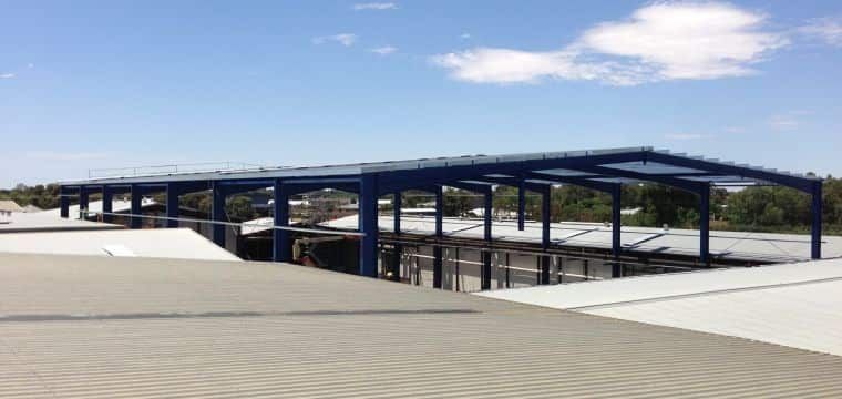 A Large Building With A Blue Roof Is Under Construction — TMF Engineering In Echuca, VIC