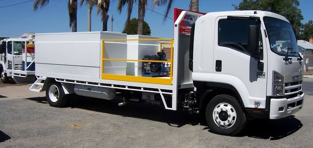 A white truck with a yellow railing is parked on the side of the road — TMF Engineering In Benalla, VIC