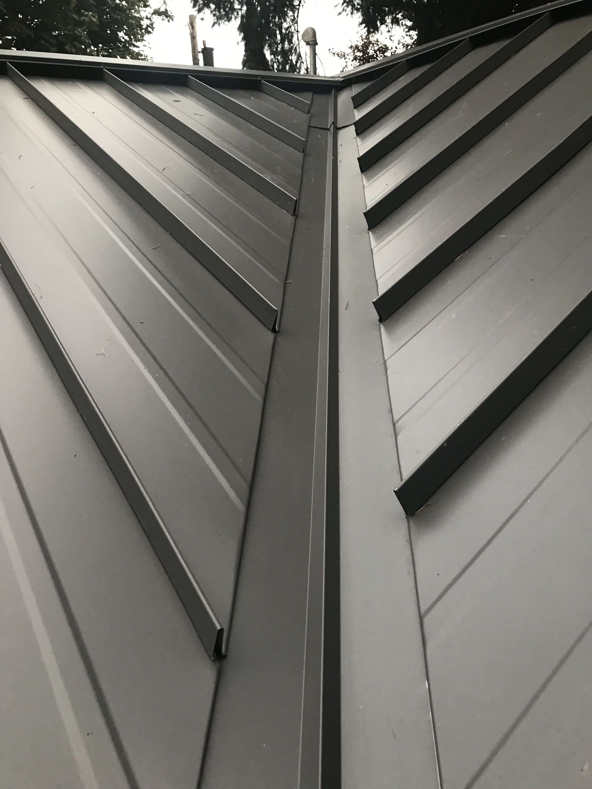 Gray metal roof with a central valley.