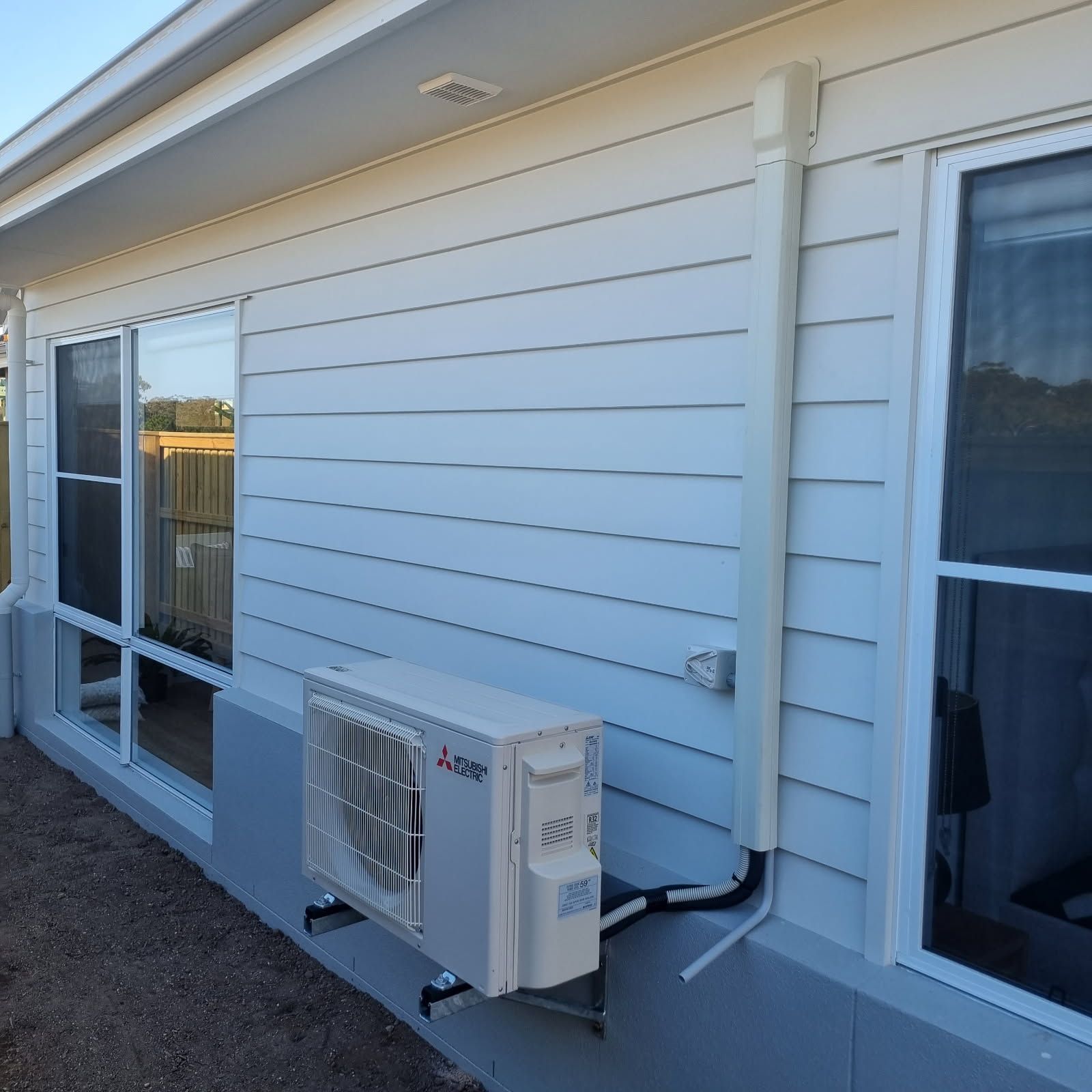 An Electrician Is Using A Multimeter To Test A Wire — Derek Knust Electrical In Mons, QLD