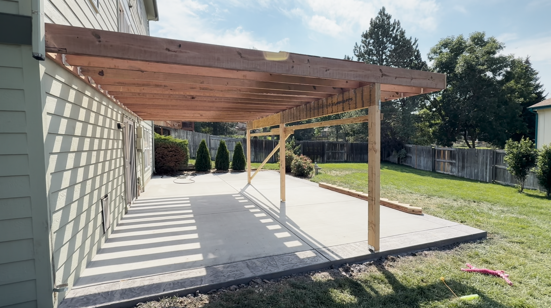 A concrete walkway is being built in front of a house.