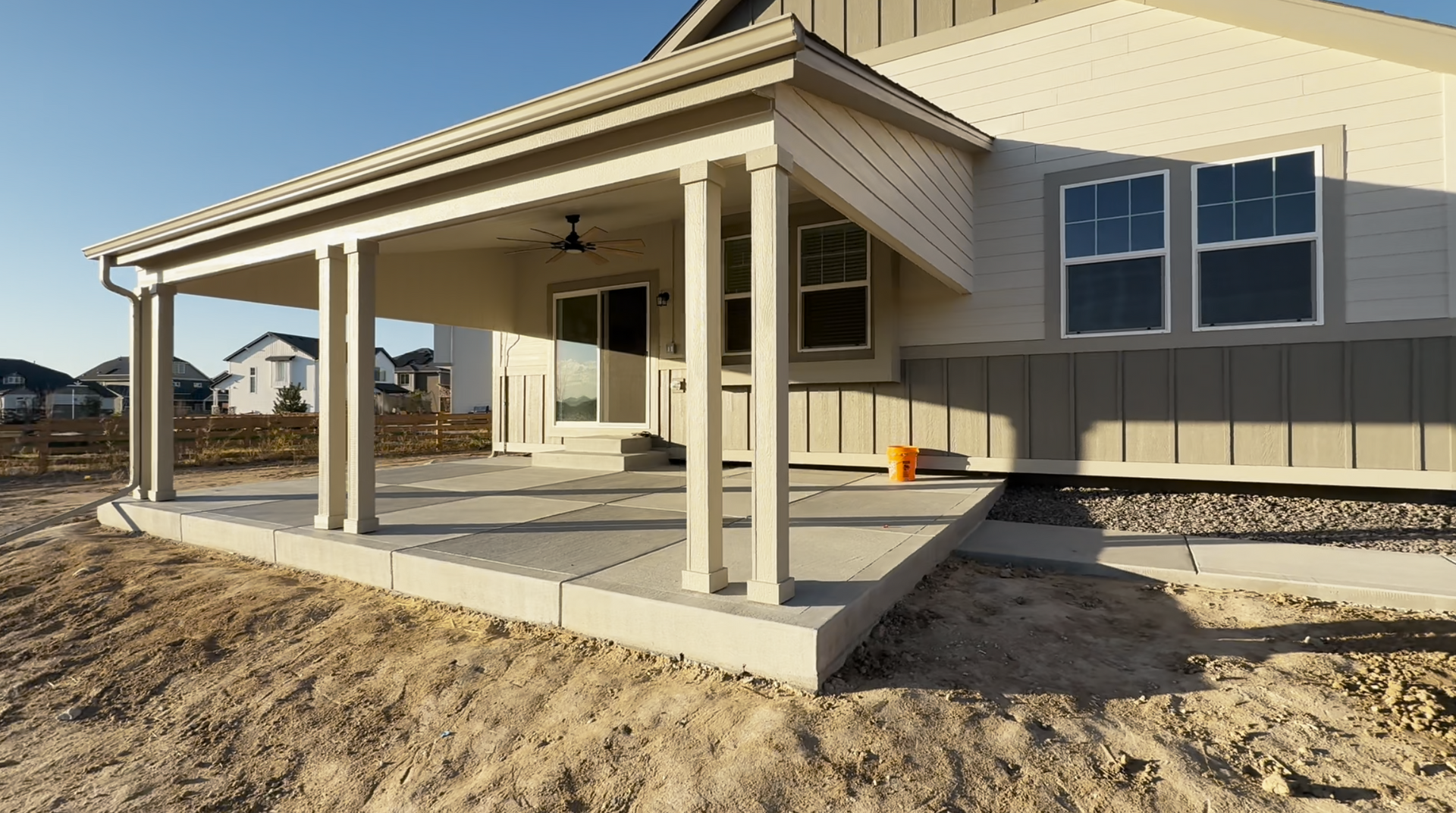 A group of construction workers are working on a concrete driveway.