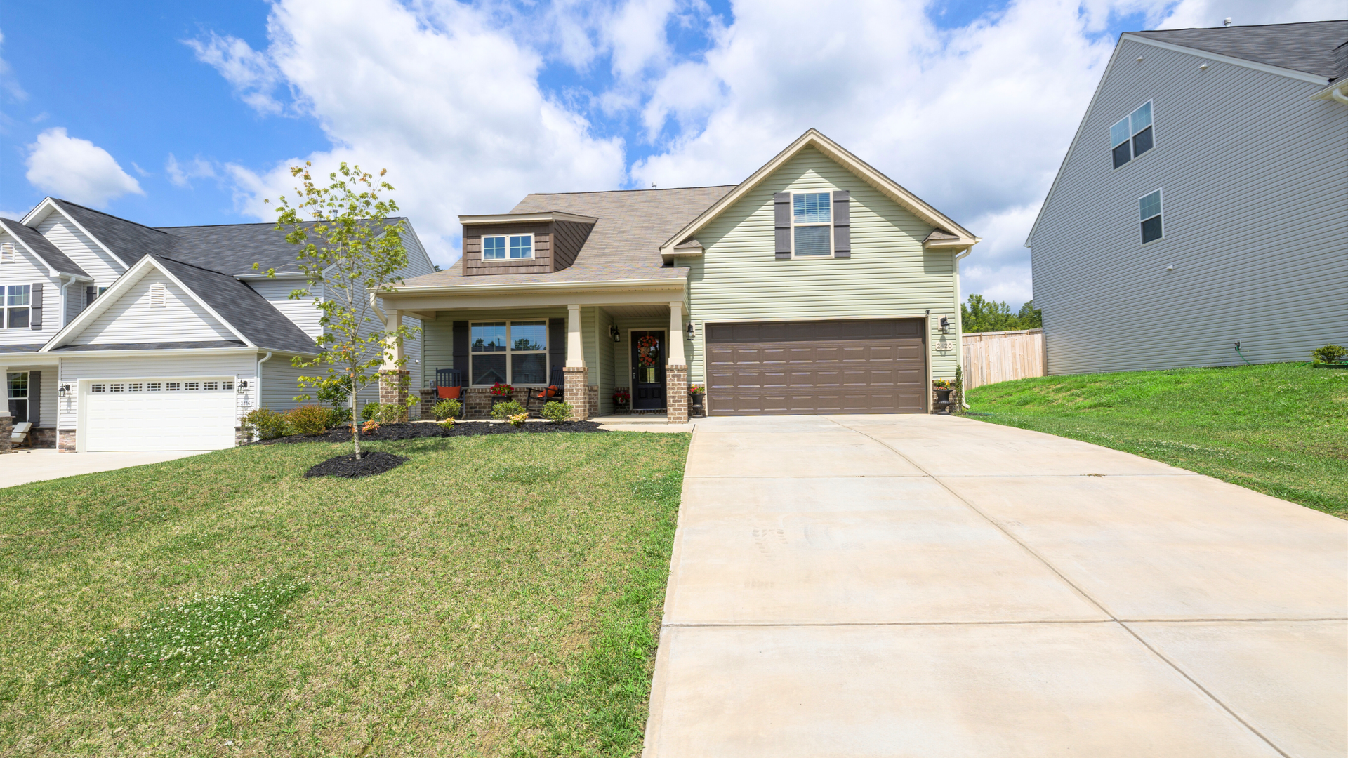 Finished broom-textured concrete driveway in Brighton CO during the curing process.