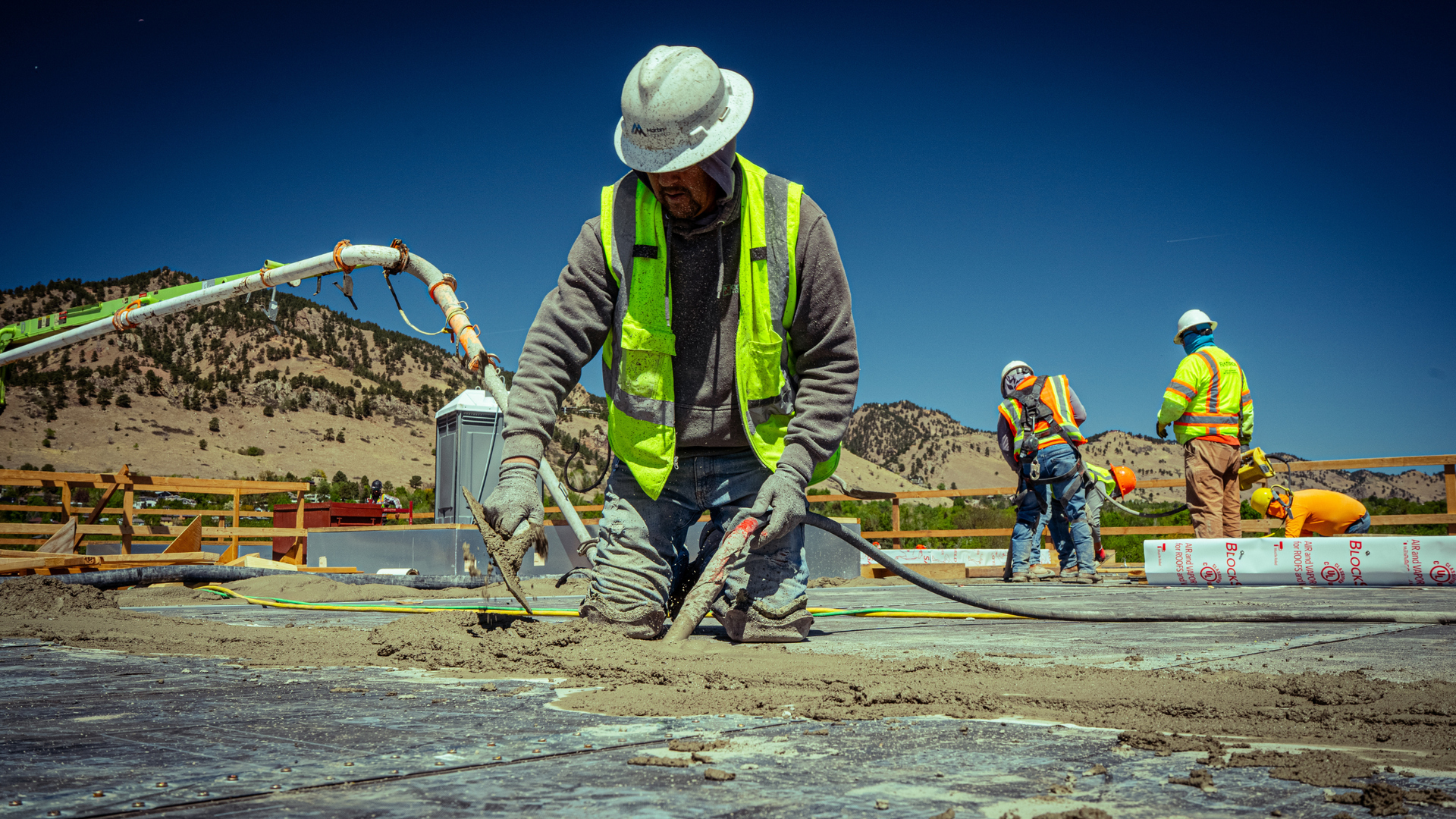 Concrete crew placing a slab on a cold clear winter day in Northern Denver with insulated curing bla