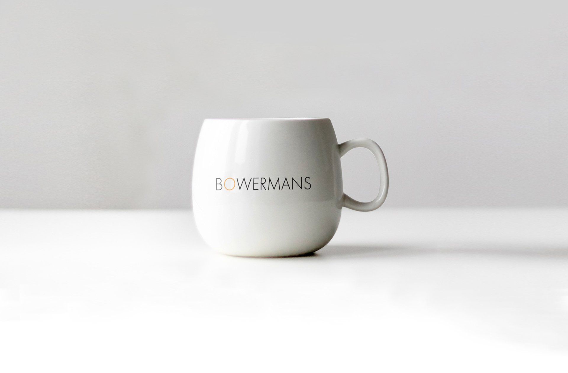 A white coffee mug with the word goodbye written on it