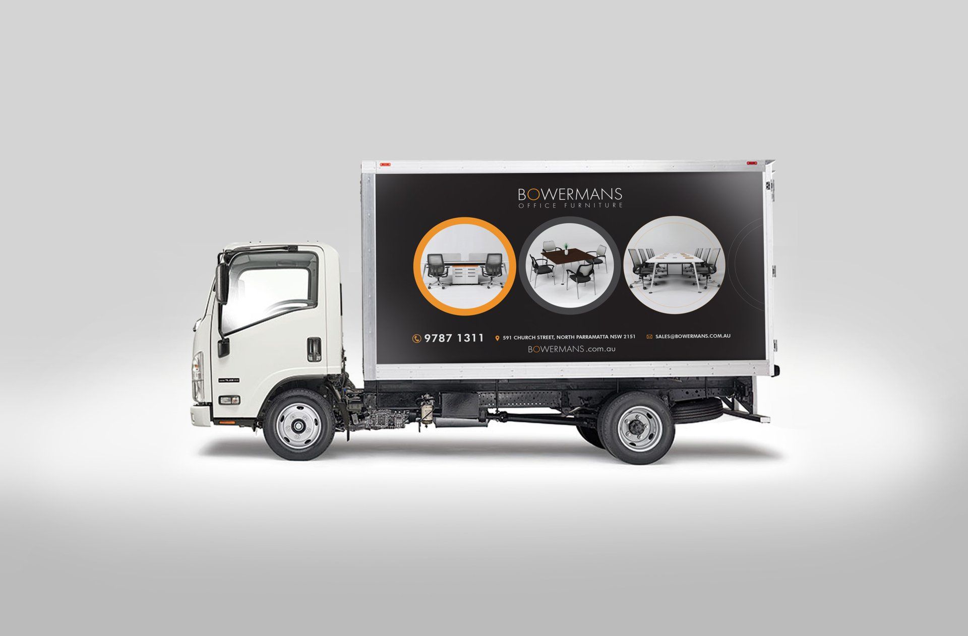 A white truck with a black advertisement on the back