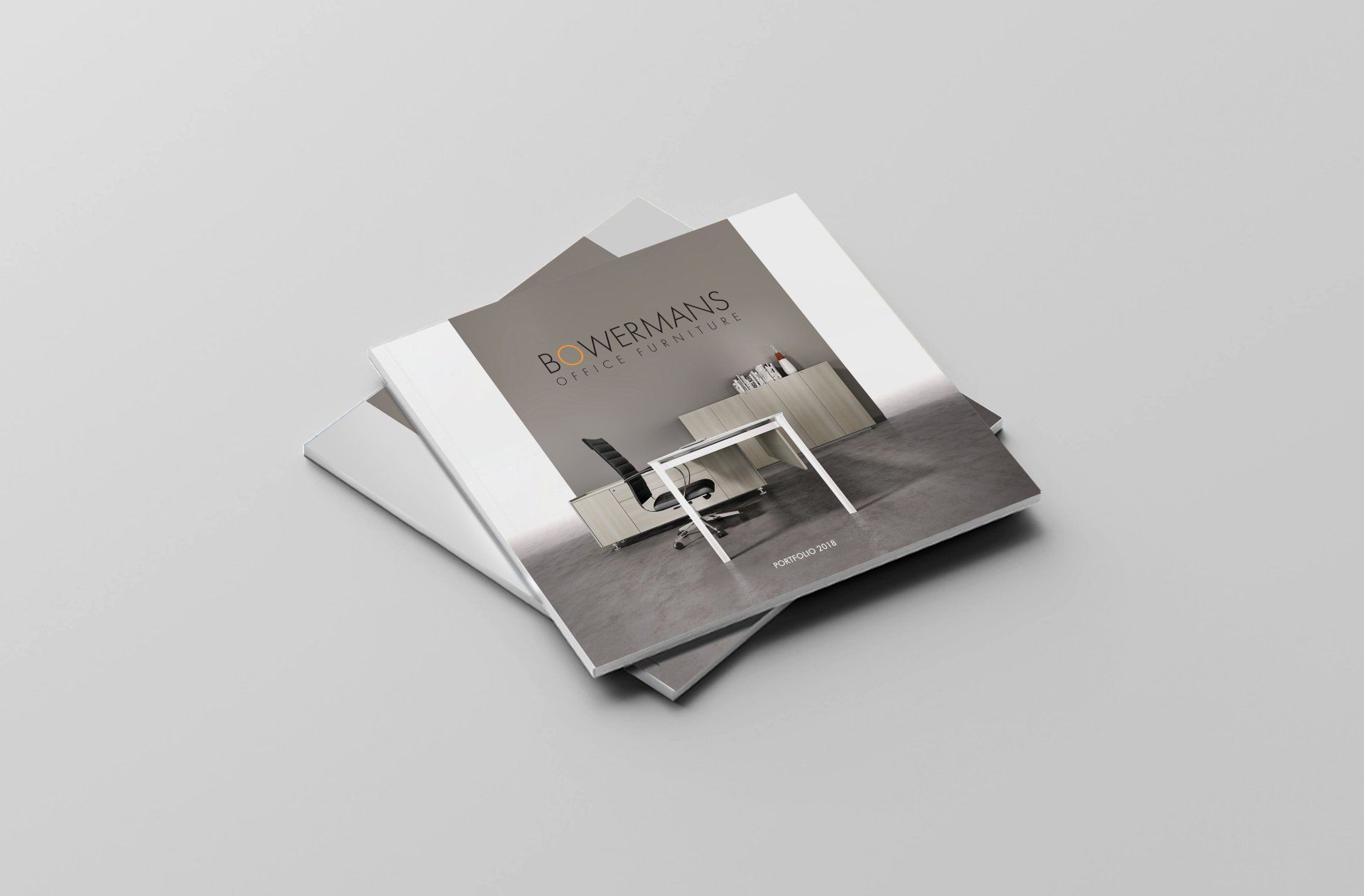 Three brochures are stacked on top of each other on a table