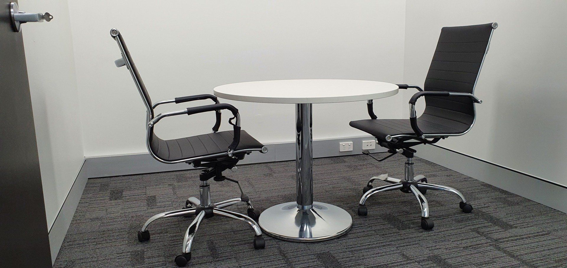 Two chairs and a table in a room with a door