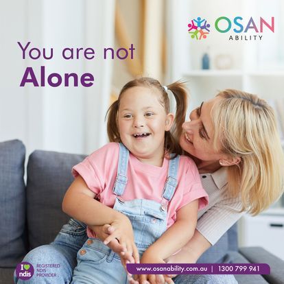 A woman is hugging a little girl on a couch.