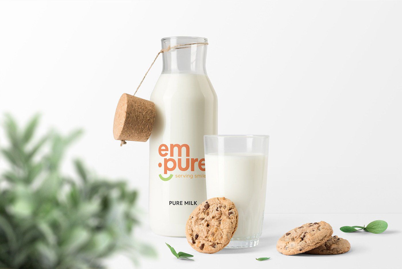 A bottle of em pure milk next to a glass of milk