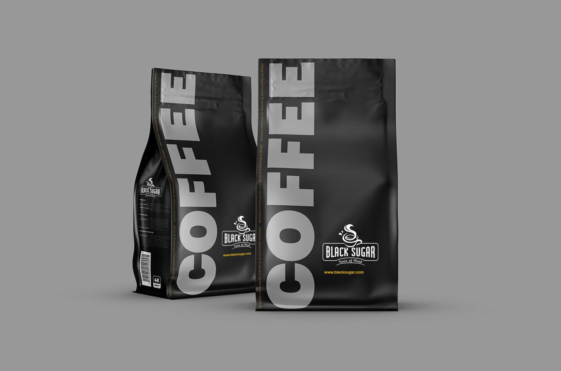 Two bags of coffee are sitting next to each other on a gray background.