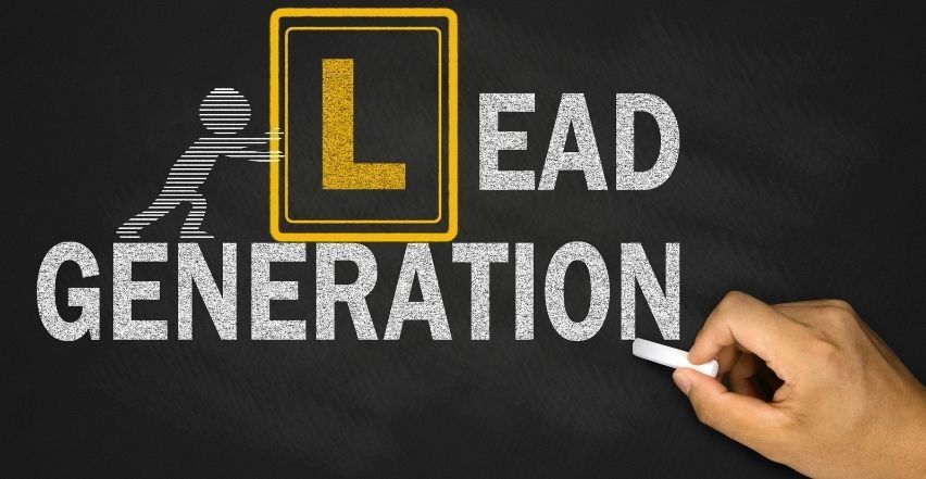 A person is writing the word lead generation on a blackboard